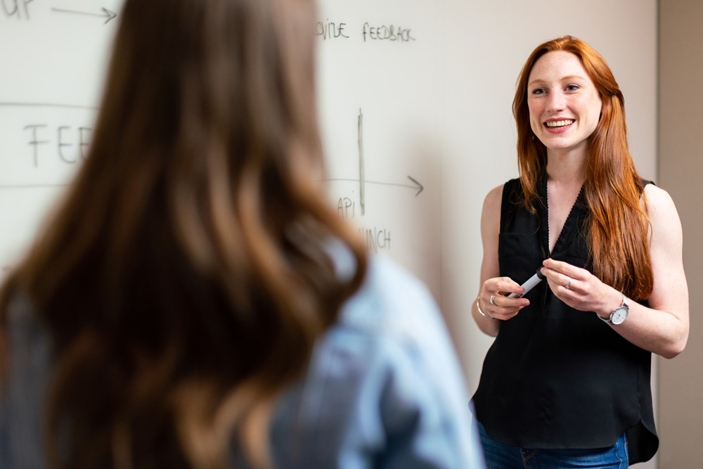 Female teacher standing infront of a student